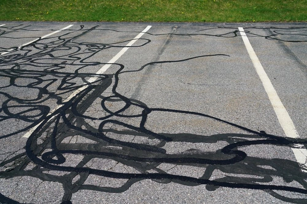 A parking lot with black paint on the ground.