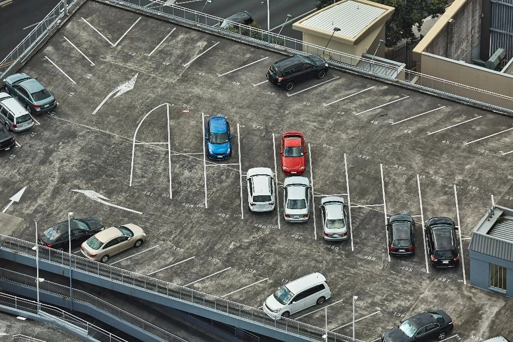 A parking lot with many cars parked in it.